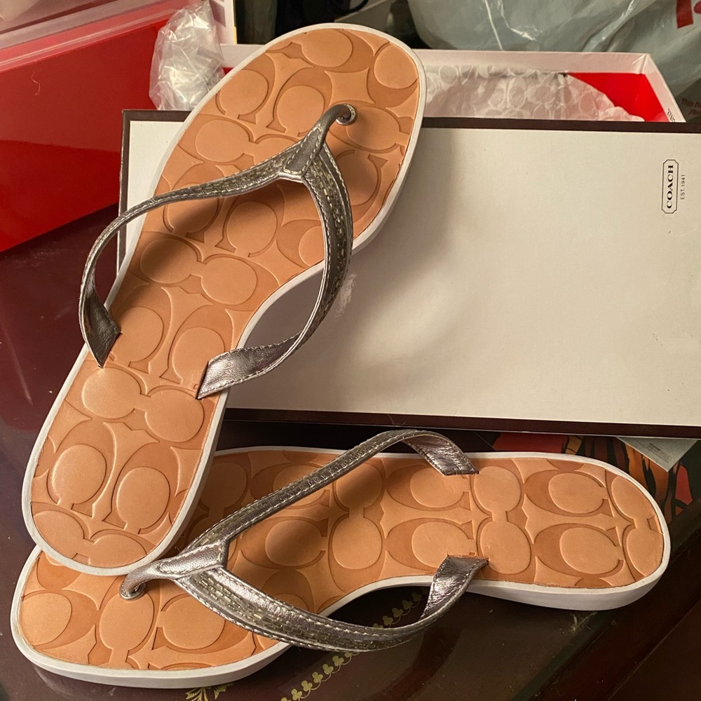Coach Laurel silver leather flip flops 
Brand new
Hard to find size 8